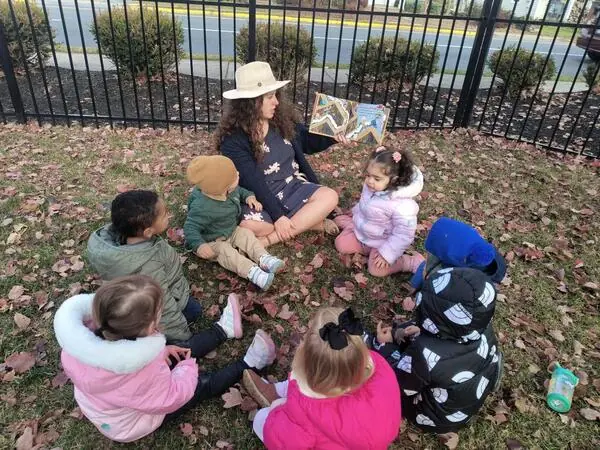 Outdoor storytime with children from the Ivy toddler program